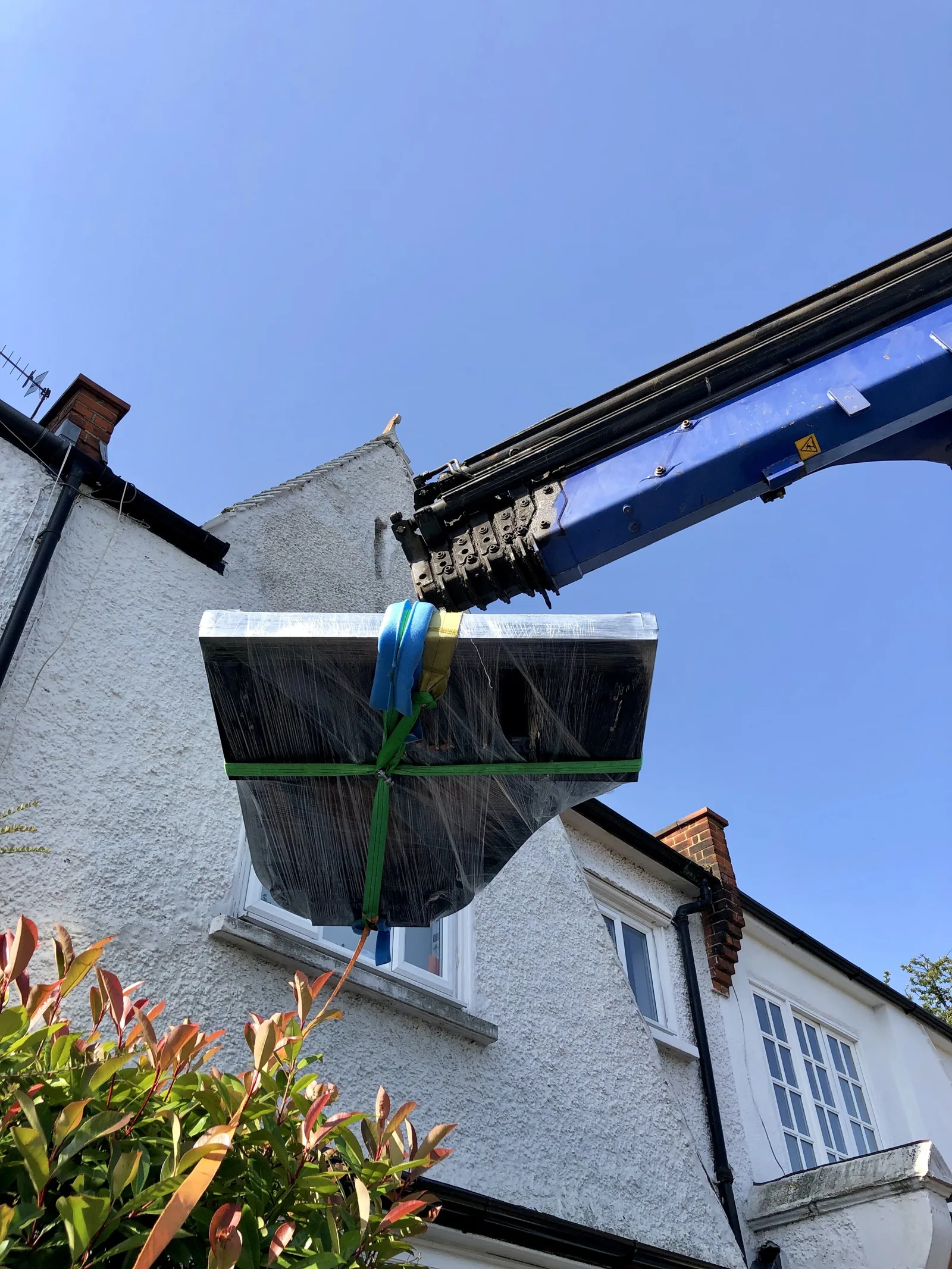 PianoSpeed crew moving a grand piano with purpose-built equipment